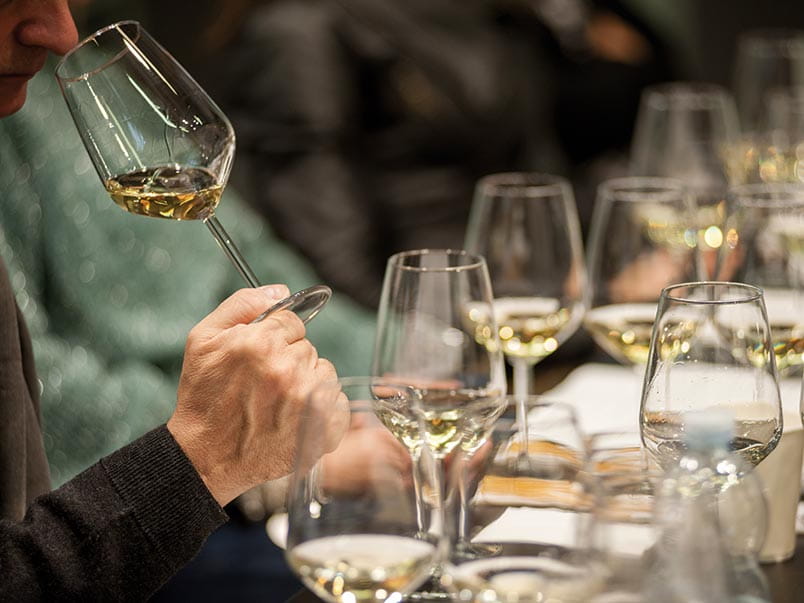 A person tasting white wine